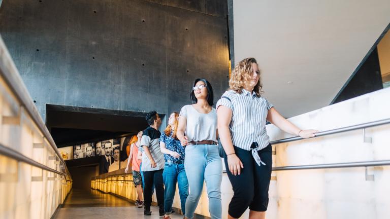 Students in a line walking on the ramp. Partially obscured.